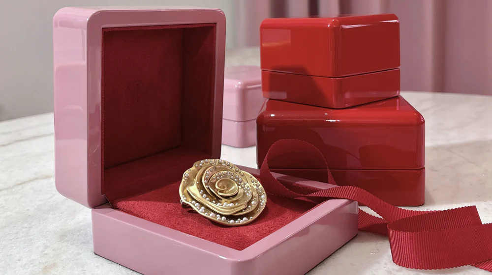 Nada Ghazal jewelry packaging with an open box displaying a brooch
